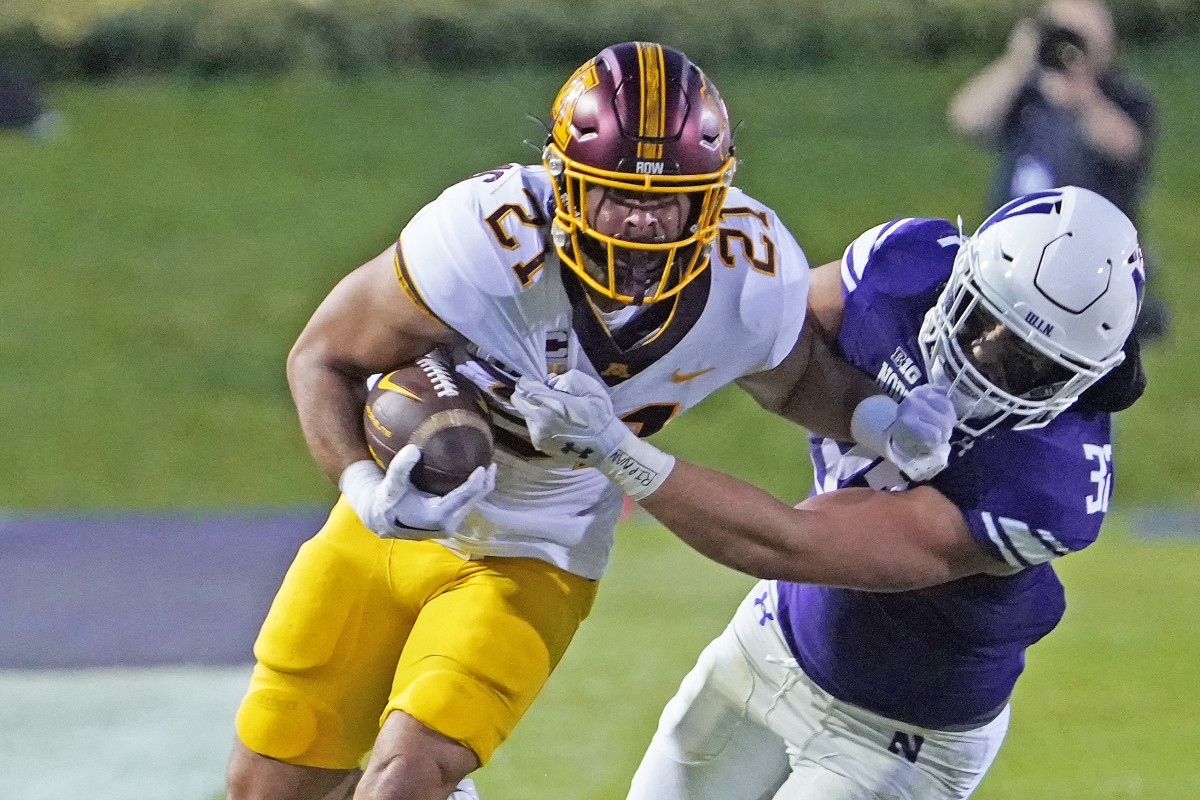 Sep 23, 2023; Evanston, Illinois, USA; Minnesota Golden Gophers running back Bryce Williams (21) tries to run past Northwestern Wildcats linebacker Bryce Gallagher (32) during the first quarter at Ryan Field.